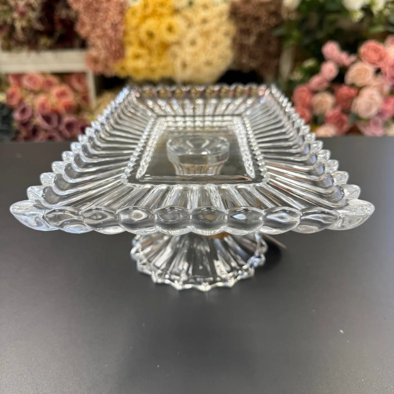 Clear glass candy dish with floral background