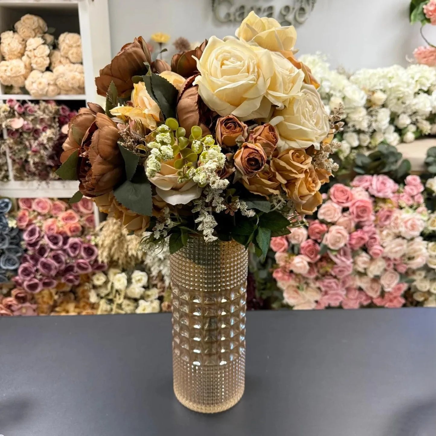 Bouquet of flowers in a decorative vase with a floral background